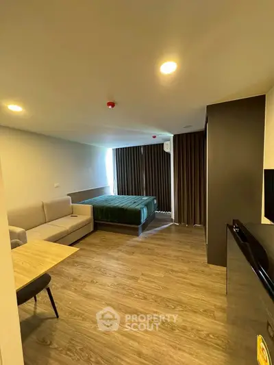 Modern studio apartment with cozy living area and stylish decor