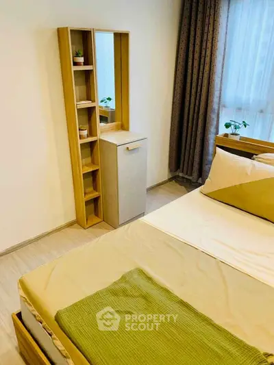 Cozy bedroom with modern furniture and natural light, perfect for relaxation and comfort.