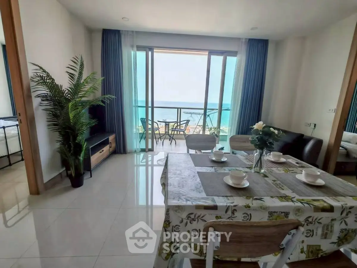 Stunning beachfront apartment with open living area and balcony view.