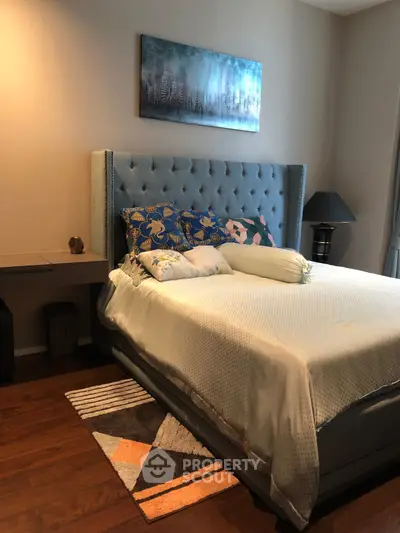 Elegant bedroom with plush bed and modern decor, perfect for a cozy retreat.