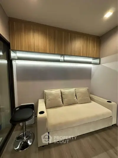 Modern living room with sleek sofa and stylish lighting, perfect for urban living.