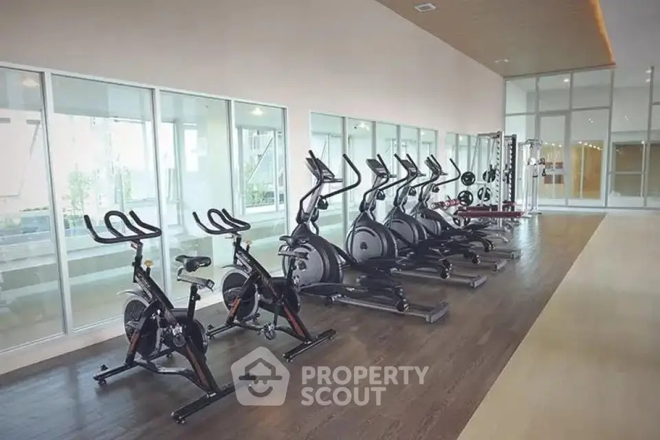 Modern gym with state-of-the-art exercise equipment in luxury apartment complex.
