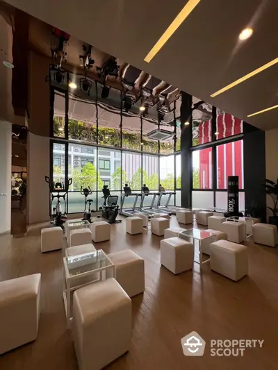 Modern gym with sleek design and state-of-the-art equipment in luxury building.