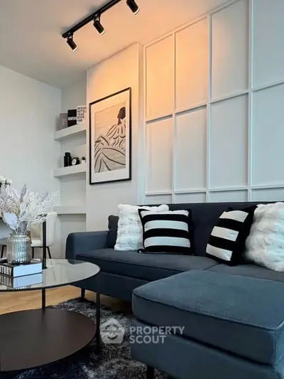 Modern living room with stylish decor, featuring a cozy sectional sofa and elegant wall art.
