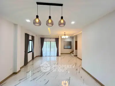 Spacious modern living room with elegant lighting and large windows.