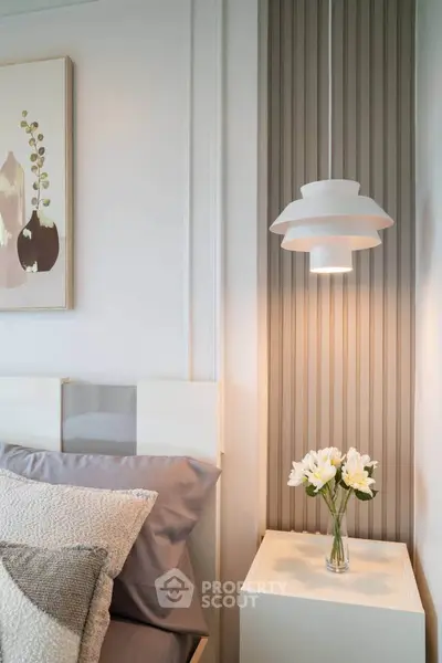 Stylish bedroom corner with modern pendant light and elegant decor