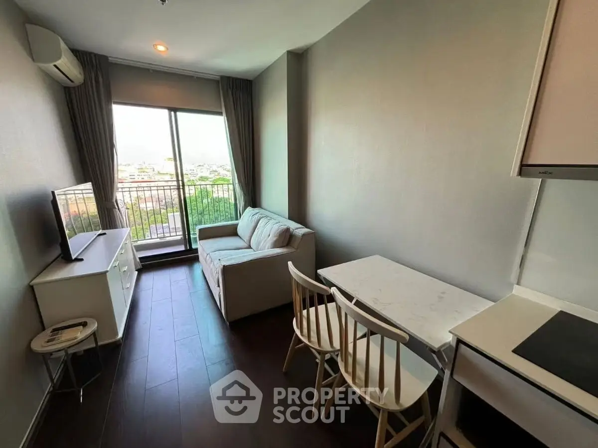 Cozy modern living room with balcony view, perfect for urban living.