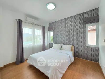 Modern bedroom with stylish wallpaper and natural light