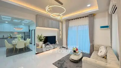 Luxurious modern living room with elegant decor and open kitchen layout, perfect for stylish living.