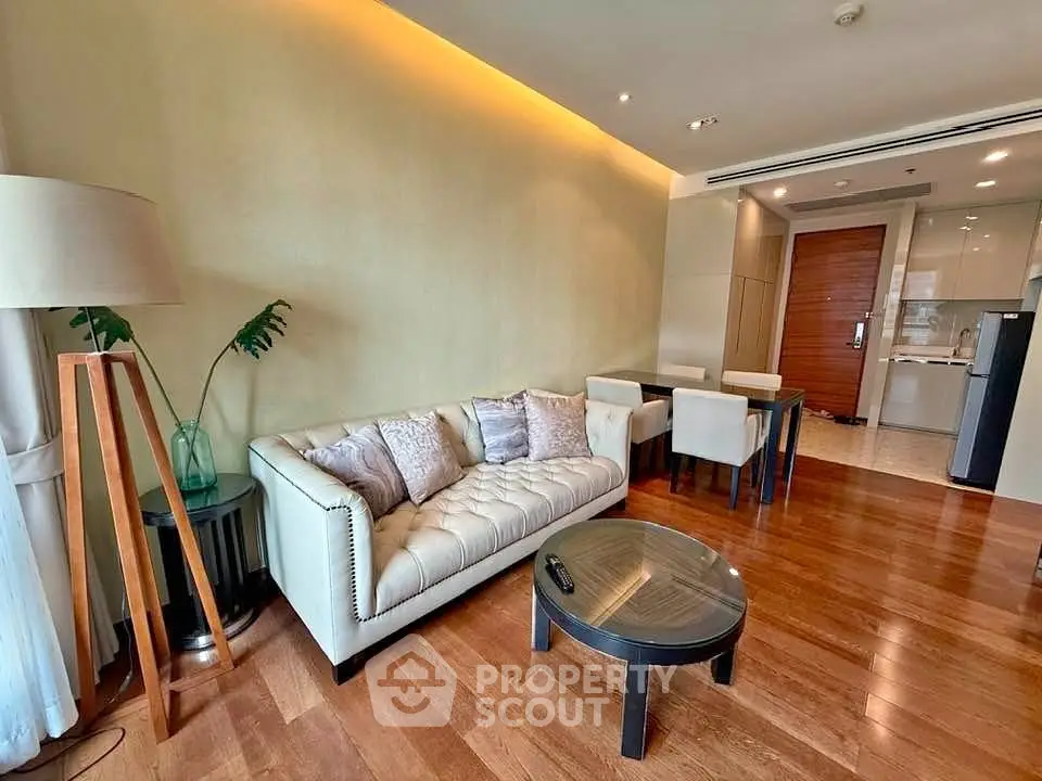 Elegant living room with modern decor and open kitchen layout in a stylish apartment.