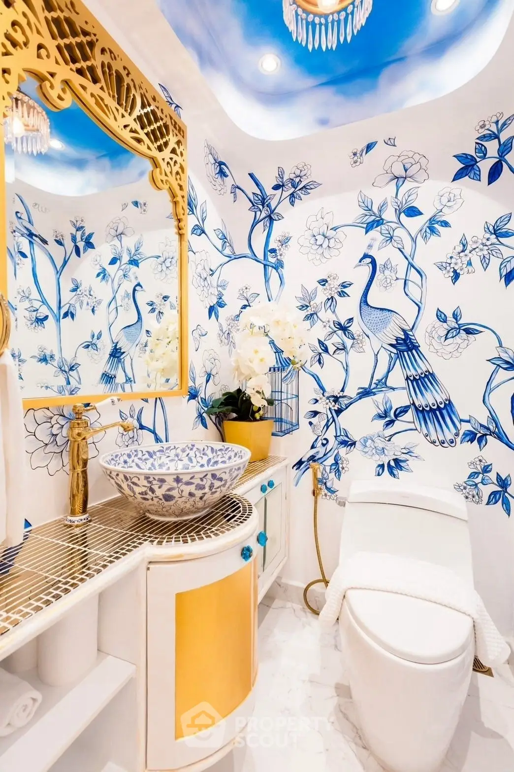Luxurious bathroom with elegant blue and gold accents, featuring a unique floral and peacock design.
