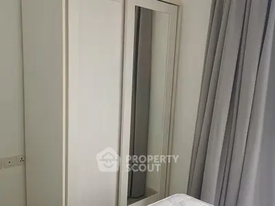 Modern bedroom with sleek wardrobe and elegant curtains