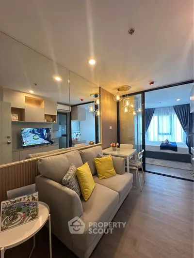 Modern living room with cozy sofa, stylish decor, and open view to bedroom in contemporary apartment.