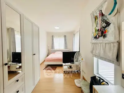 Bright and cozy bedroom with modern furnishings and ample natural light