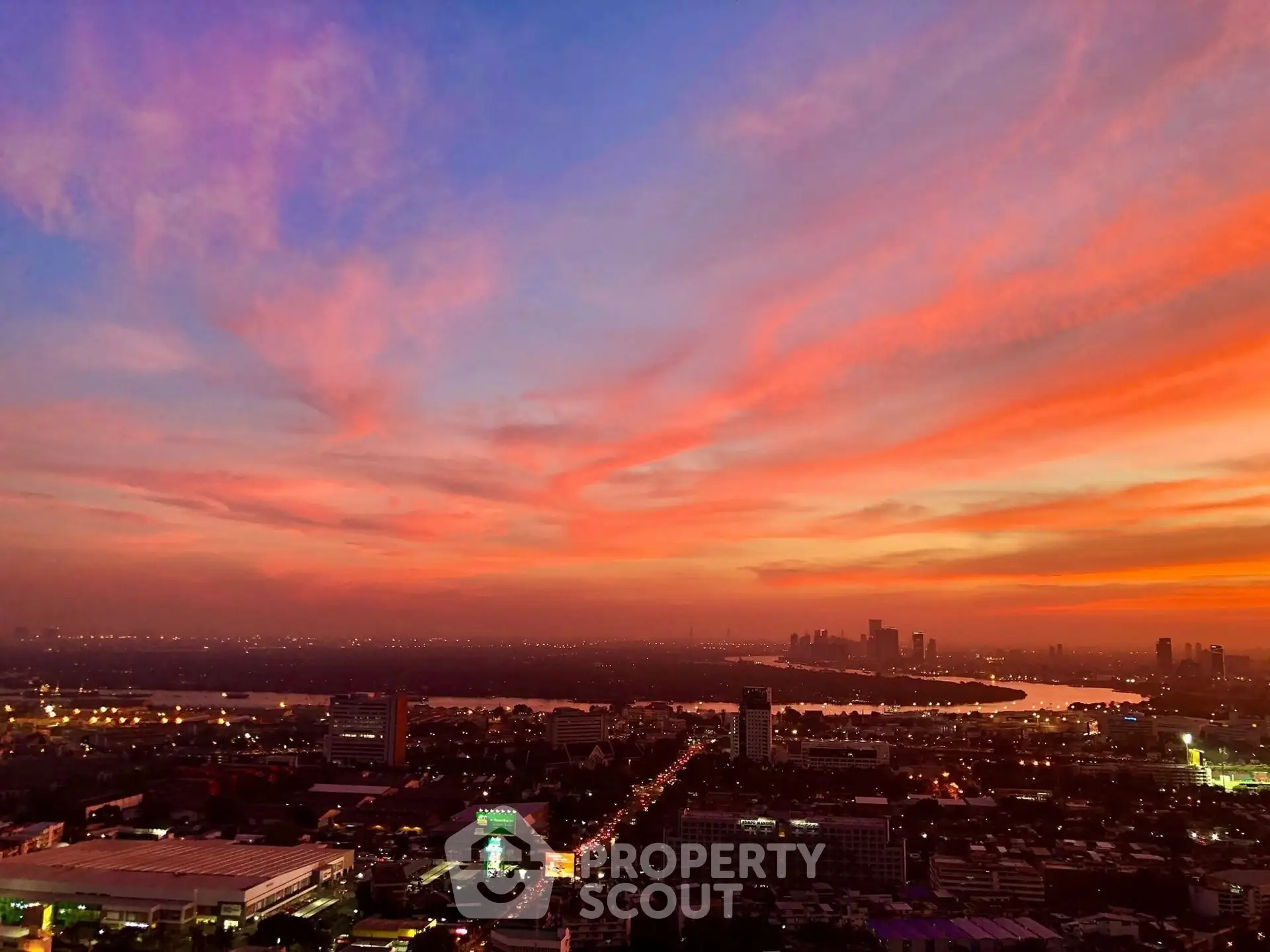 Stunning cityscape view at sunset with vibrant sky colors and distant skyline.