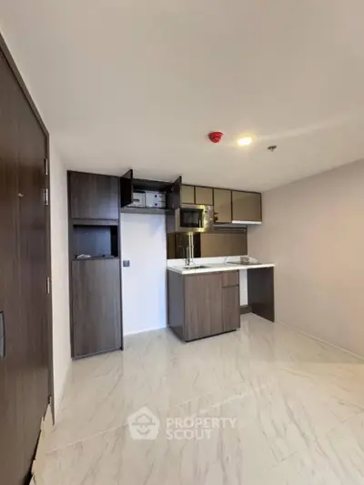 Modern kitchen with sleek cabinetry and open layout in a stylish apartment