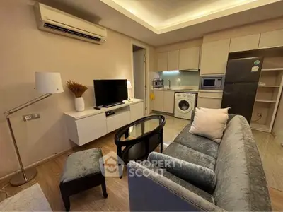 Modern living room with sleek furniture and integrated kitchen appliances, perfect for urban living.