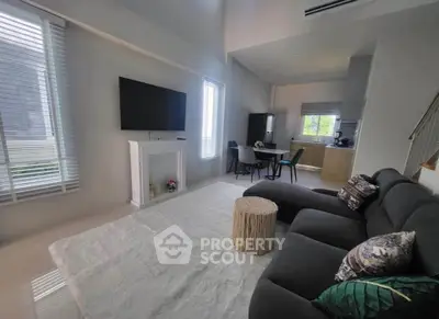 Spacious modern living room with cozy sectional sofa and large windows