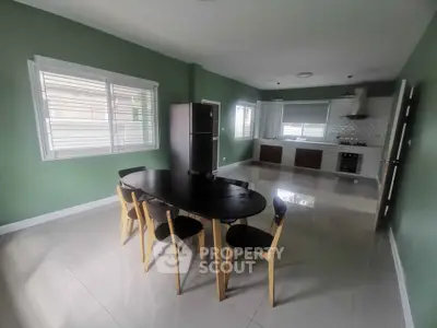 Spacious kitchen with dining area, featuring modern appliances and sleek design.