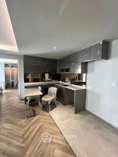 Modern kitchen with sleek cabinetry and open layout in a stylish apartment.