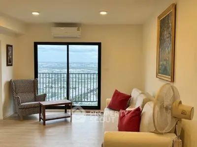 Spacious living room with stunning city view, cozy seating, and modern decor.