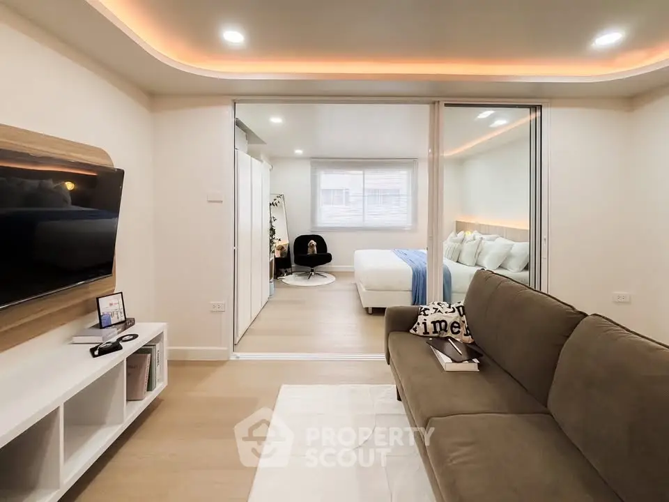 Modern studio apartment with cozy living area and stylish bedroom