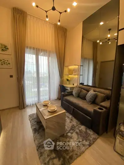 Modern living room with elegant decor and large windows in a cozy apartment.