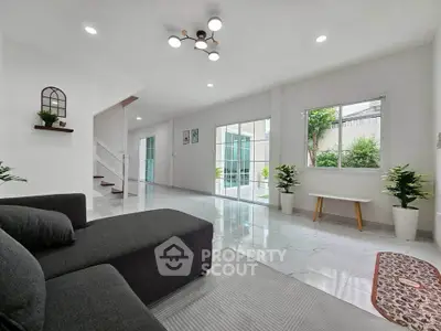 Spacious modern living room with large windows and stylish decor