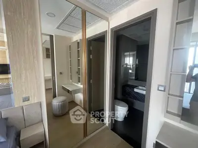 Modern apartment interior with mirrored closet and sleek bathroom design