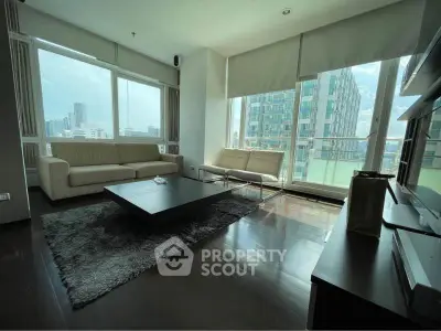 Spacious modern living room with large windows and city view