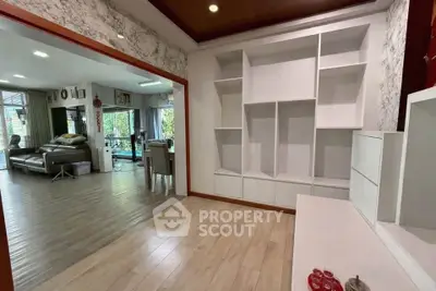 Spacious open-plan living room with modern shelving and elegant decor