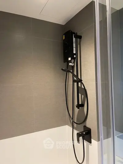 Modern bathroom with sleek shower design and neutral tile accents