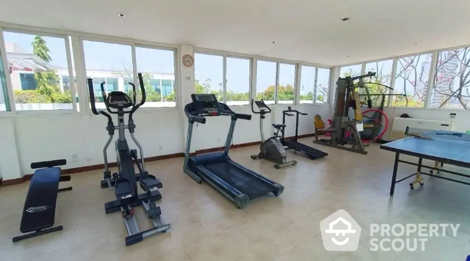 Spacious home gym with modern exercise equipment and natural light