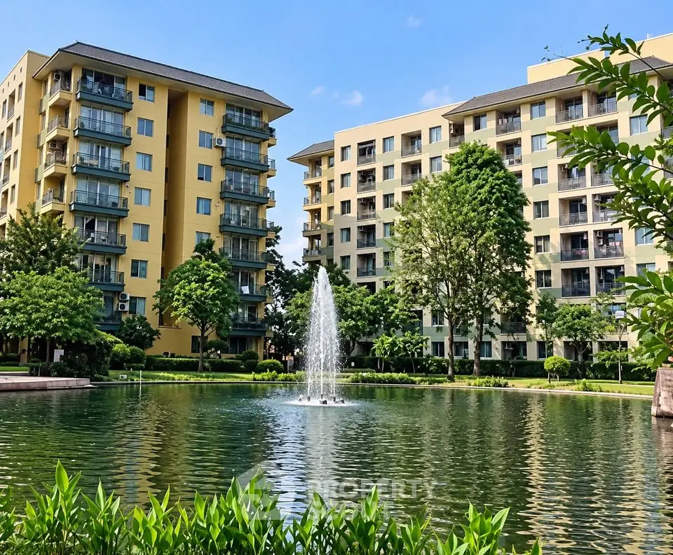 Stunning view of modern apartment buildings with a serene pond and fountain, surrounded by lush greenery.