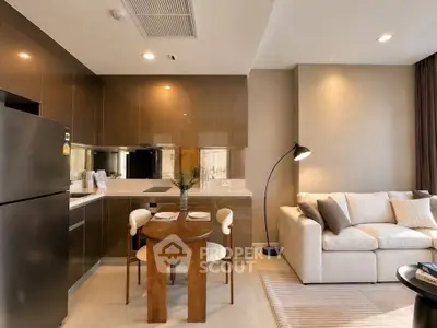 Modern open-layout kitchen and living room with sleek design and cozy ambiance.