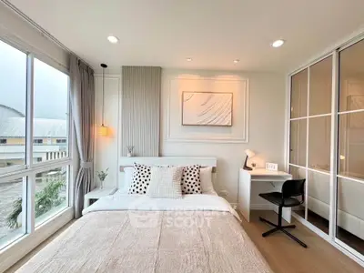 Modern bedroom with large windows and stylish decor