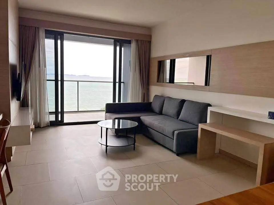 Modern living room with stunning ocean view and sleek furniture design.