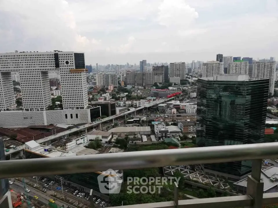 Stunning cityscape view from high-rise balcony overlooking urban skyline.