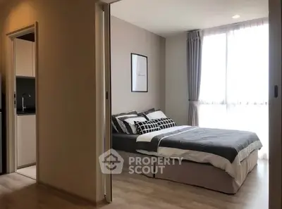 Modern bedroom with natural light and stylish decor in a contemporary apartment.