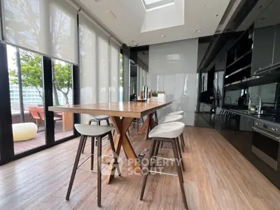 Luxurious modern kitchen with open layout and sleek design, featuring high-end appliances and a spacious dining area.