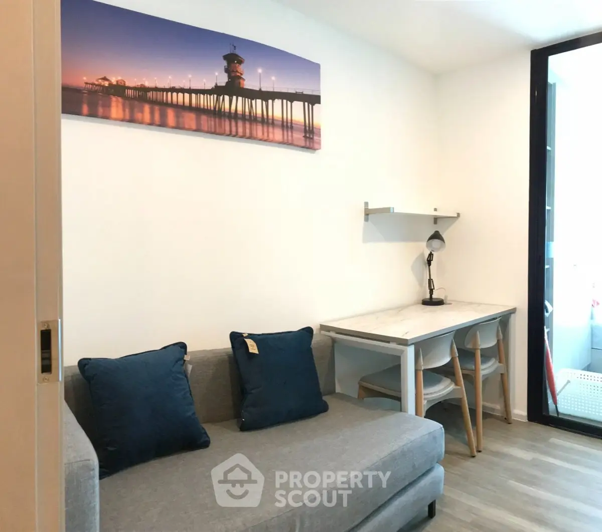 Cozy living room with modern sofa and stylish workspace in a bright apartment.