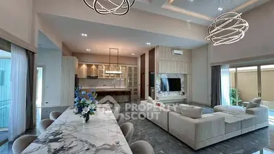 Luxurious open-plan living room with modern kitchen and elegant dining area