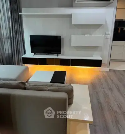Modern living room with sleek TV unit and ambient lighting