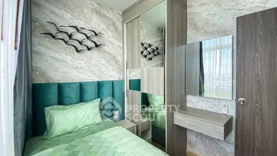 Stylish bedroom with modern decor and large mirror in a cozy apartment.