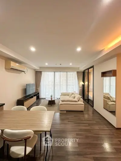 Spacious modern living room with elegant decor and large windows