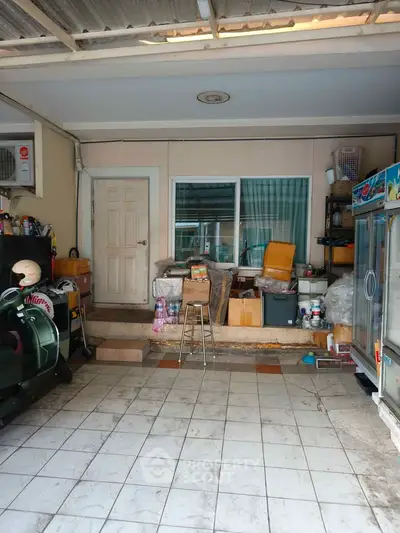 Spacious garage with storage potential and tiled flooring, ideal for versatile use in a residential property.