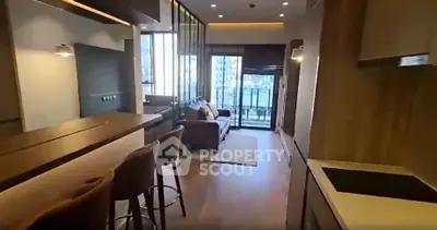 Modern open-layout living room with stylish kitchen and balcony view