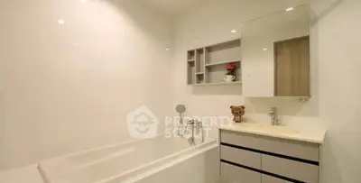 Modern bathroom with sleek design, featuring a bathtub and stylish vanity in a bright, minimalist setting.