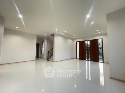 Spacious modern living room with glossy floors and large windows