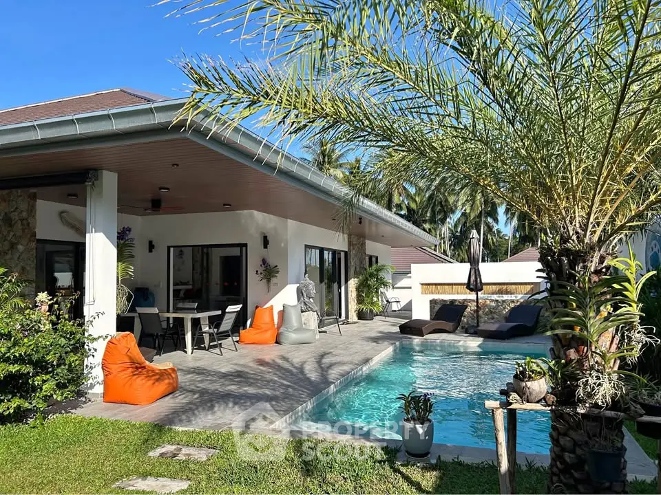 Luxurious villa with private pool and lush garden, perfect for tropical living.